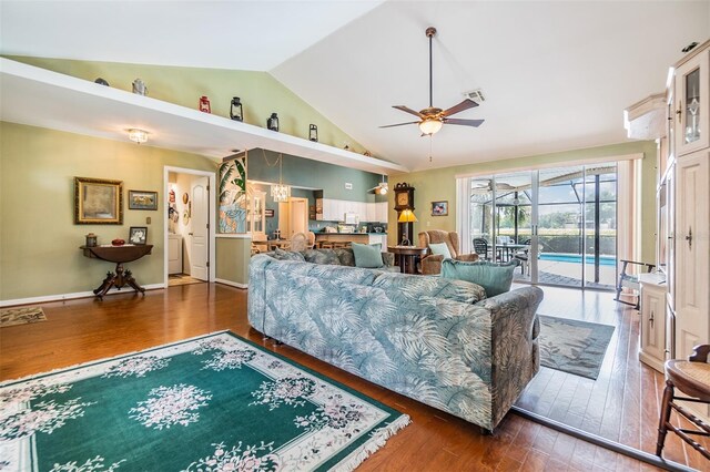 living room featuring lofted ceiling, ceiling fan, and dark hardwood / wood-style floors