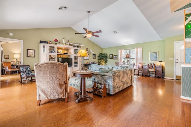 living room featuring lofted ceiling, hardwood / wood-style floors, and ceiling fan