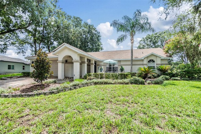 single story home with a garage and a front yard