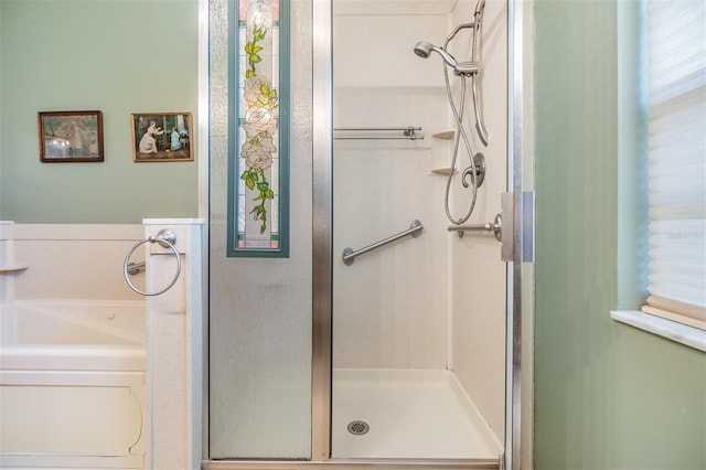 bathroom featuring shower with separate bathtub