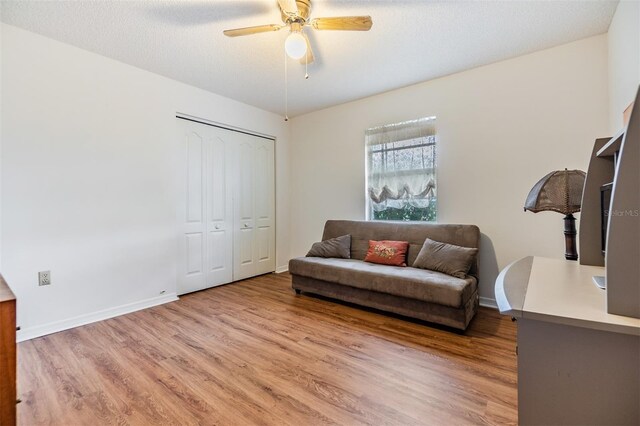 sitting room featuring a textured ceiling, ceiling fan, and hardwood / wood-style floors