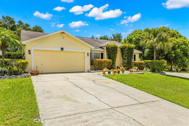 ranch-style home featuring a garage and a front lawn