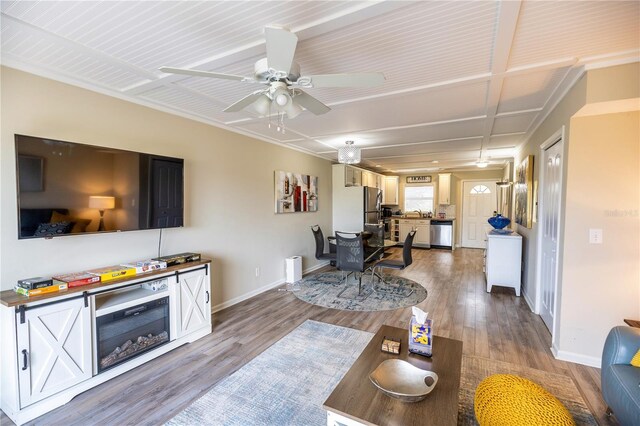 living room featuring ceiling fan and hardwood / wood-style flooring