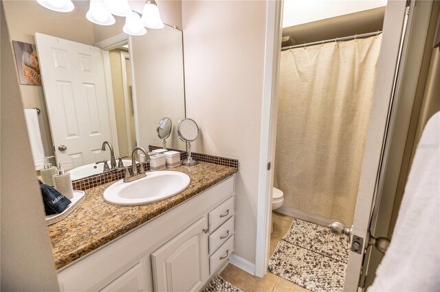 bathroom with tile patterned floors, vanity, and toilet