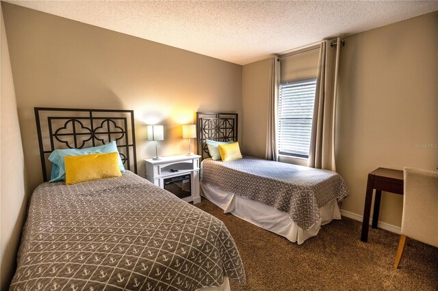 bedroom featuring carpet floors and a textured ceiling