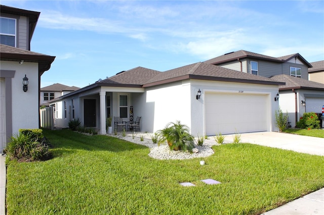 view of front of property with a front yard and a garage