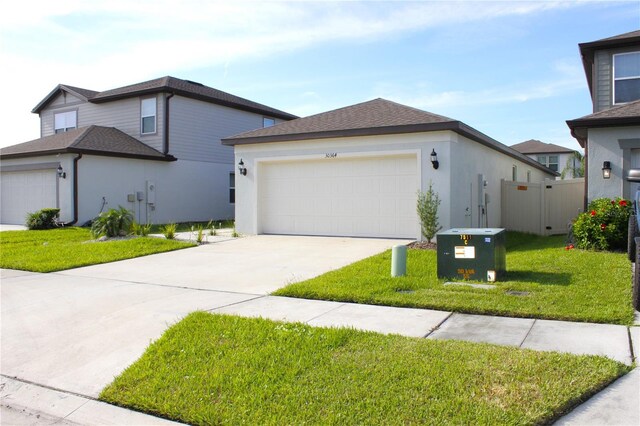 view of front of house with a front yard and a garage