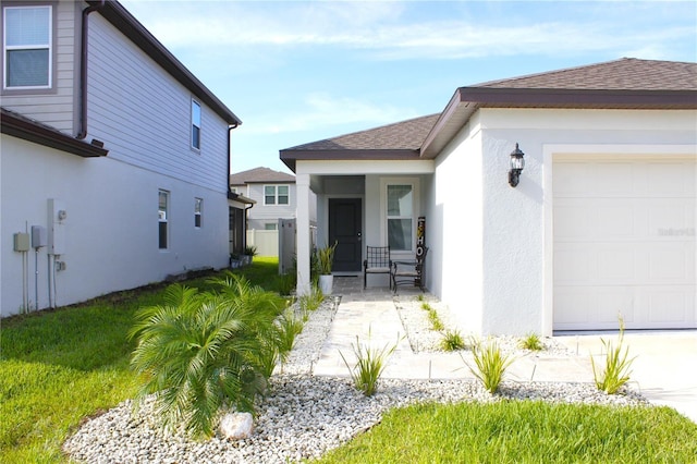 exterior space with a porch, a garage, and a yard