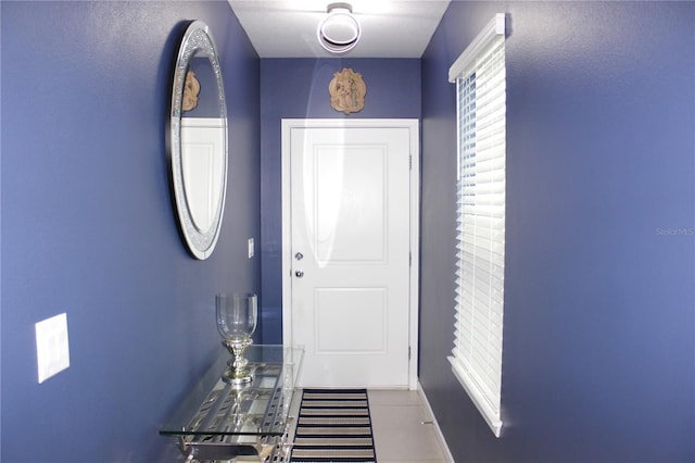 doorway to outside featuring tile patterned flooring