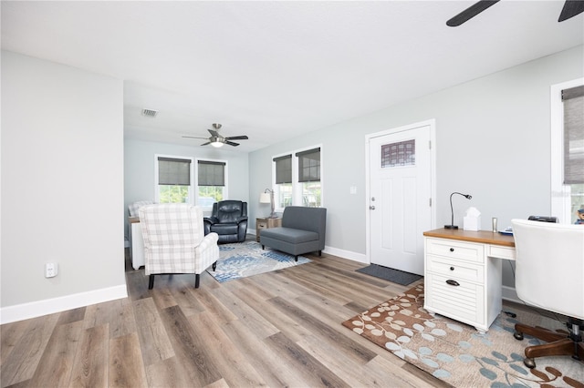 office with ceiling fan and light wood-type flooring