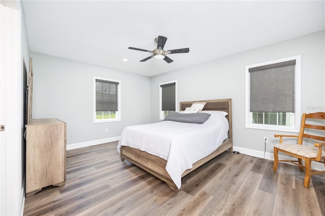 bedroom with hardwood / wood-style flooring and ceiling fan