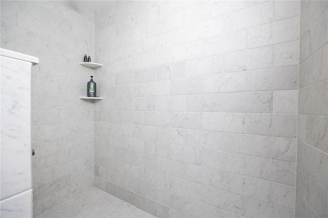 bathroom with tiled shower