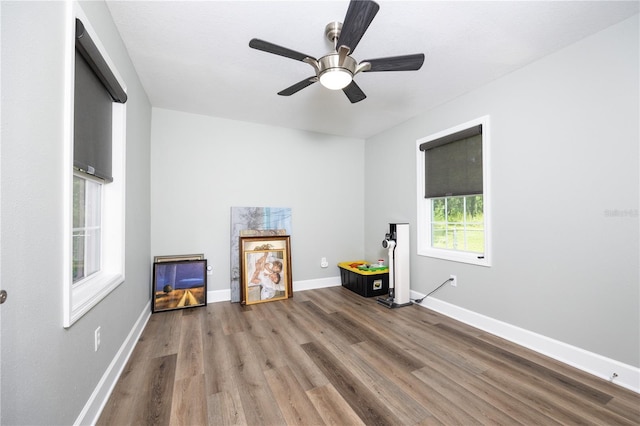 misc room featuring wood-type flooring and ceiling fan