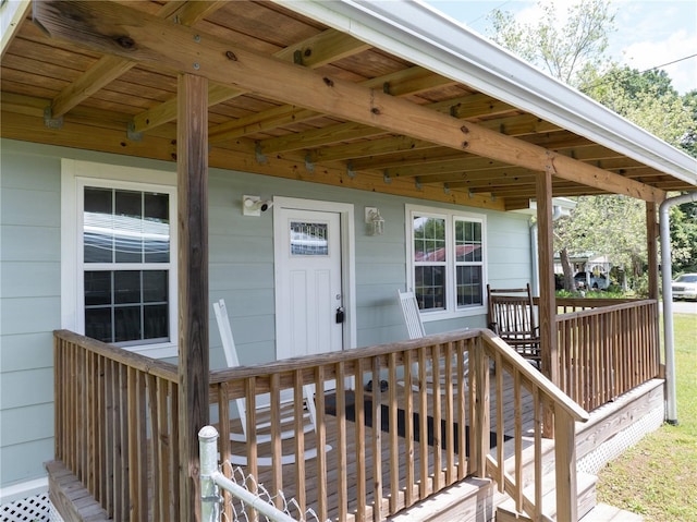 view of exterior entry with a wooden deck