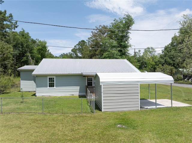 view of outbuilding with a yard and a carport