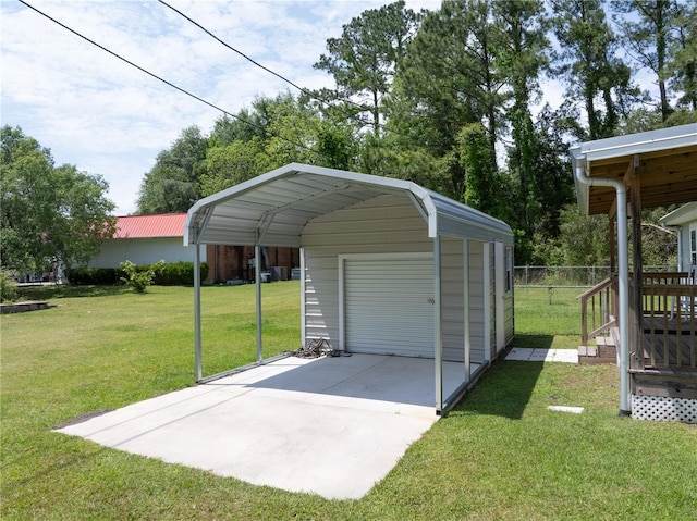 garage with a carport and a lawn