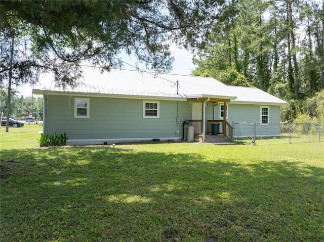 rear view of house featuring a yard