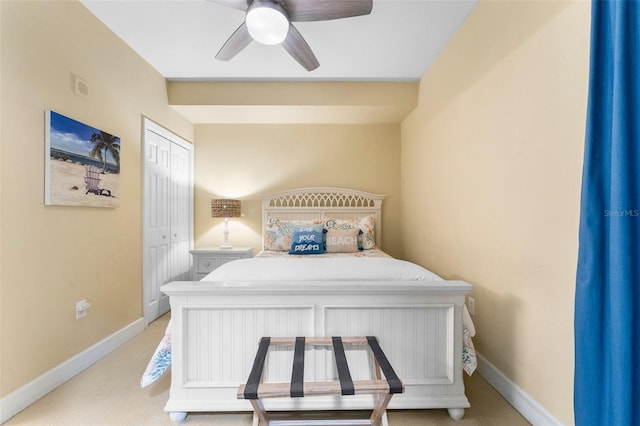 bedroom with light colored carpet, a closet, and ceiling fan