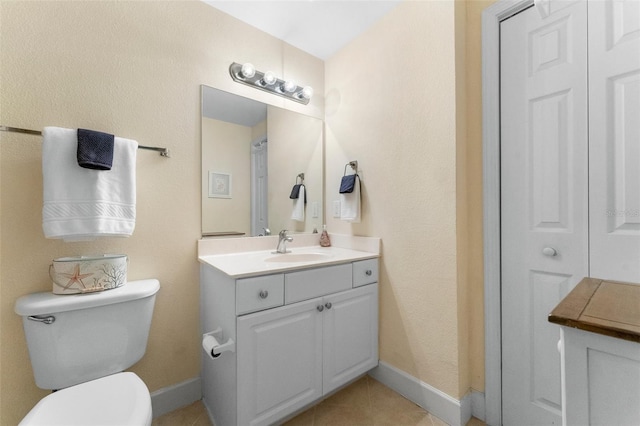 bathroom featuring tile patterned floors, vanity, and toilet