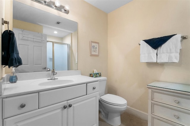 bathroom with tile patterned floors, vanity, toilet, and walk in shower