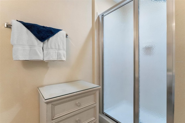 bathroom featuring a shower with door