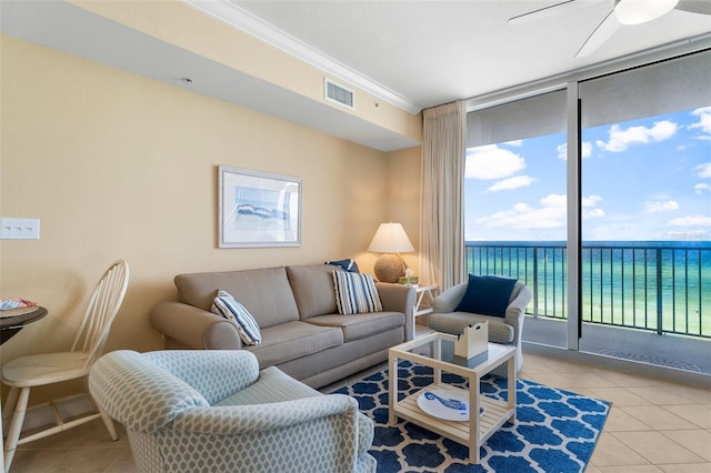 living room with light tile patterned floors, ornamental molding, a water view, and visible vents