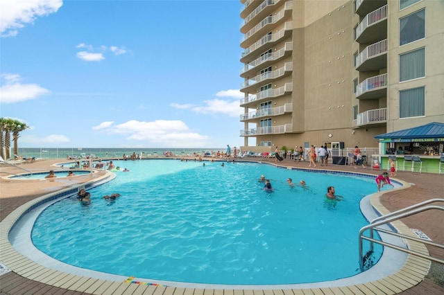 view of swimming pool featuring a gazebo, a water view, and a patio area