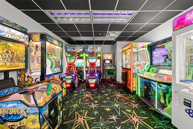 rec room with dark colored carpet and a drop ceiling