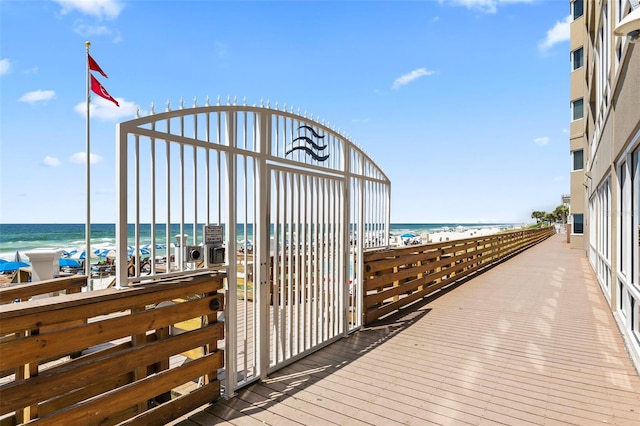 view of dock with a view of the beach and a water view