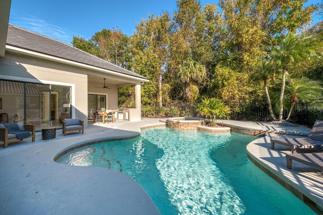 view of pool with ceiling fan, a patio, and an in ground hot tub