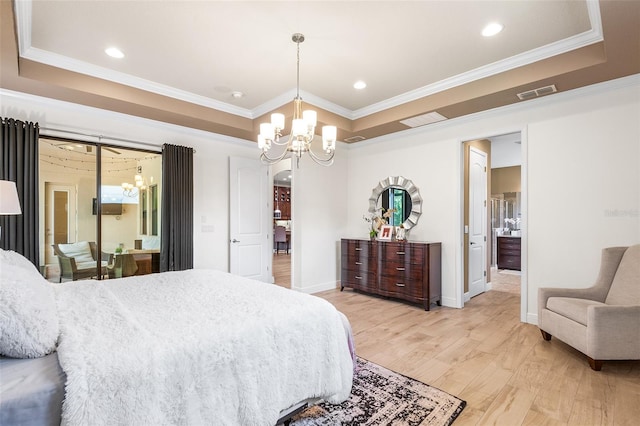 bedroom featuring a raised ceiling, a chandelier, wood-type flooring, and ornamental molding