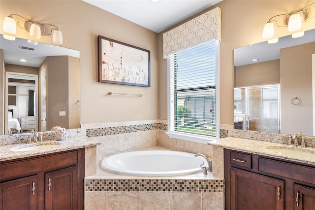 bathroom featuring separate shower and tub and vanity