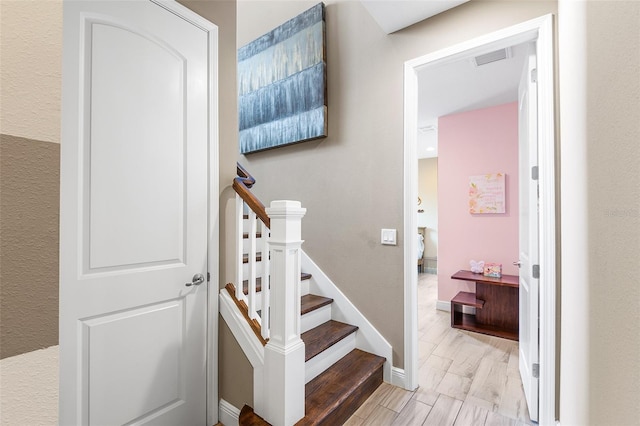 stairs with hardwood / wood-style floors