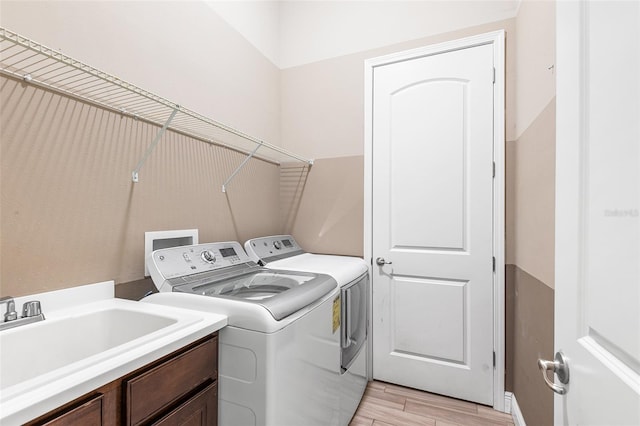 laundry area featuring independent washer and dryer and sink