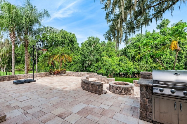 view of patio / terrace with a fire pit and a grill