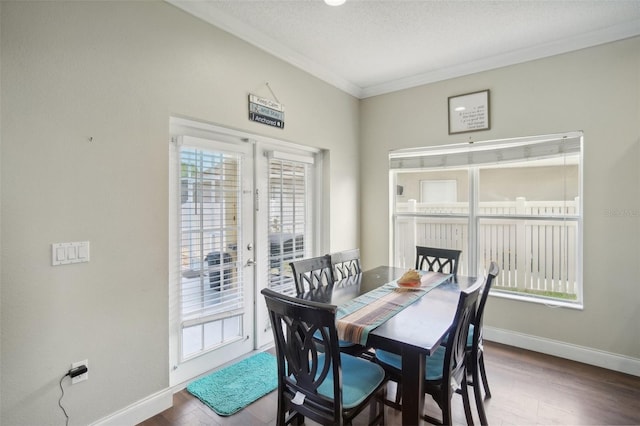 dining area featuring hardwood / wood-style floors, ornamental molding, a textured ceiling, and french doors