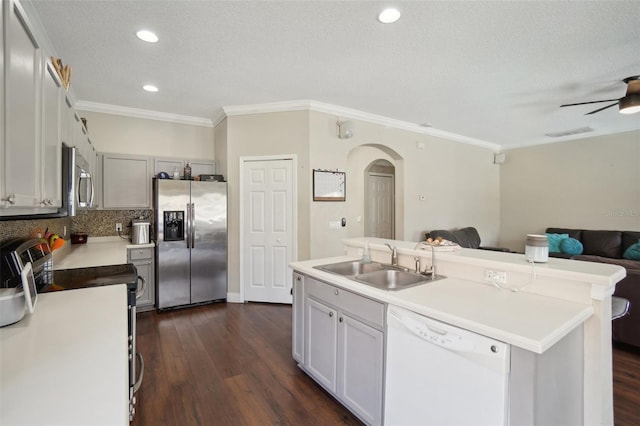 kitchen with sink, a kitchen island with sink, appliances with stainless steel finishes, ornamental molding, and a textured ceiling