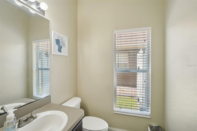 bathroom with toilet and vanity