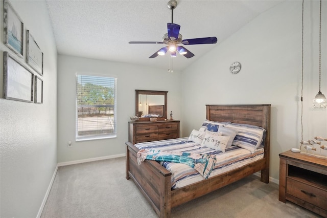 bedroom with light carpet, ceiling fan, a textured ceiling, and vaulted ceiling