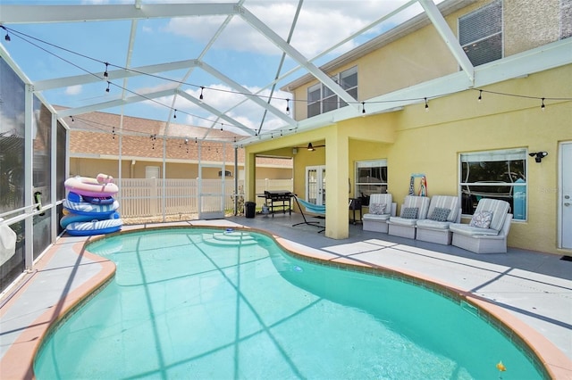 view of swimming pool featuring a lanai, an outdoor hangout area, and a patio