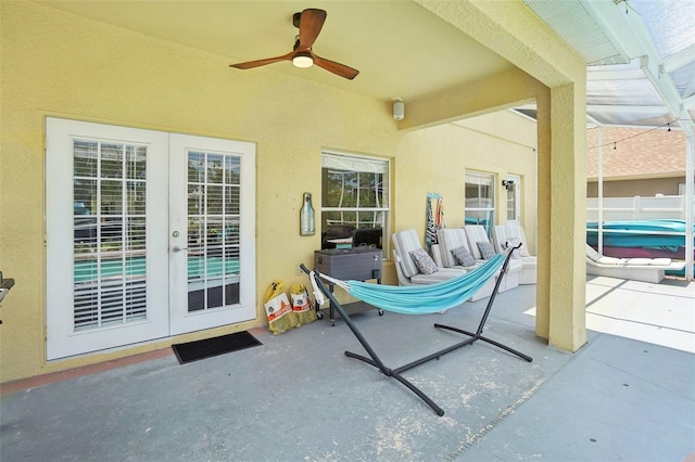 view of patio / terrace featuring ceiling fan and french doors