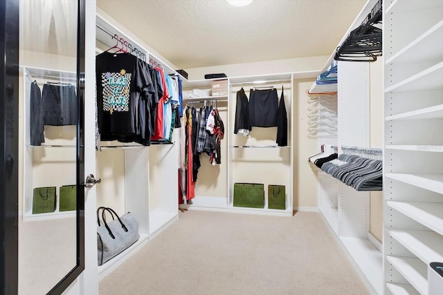 walk in closet with carpet floors