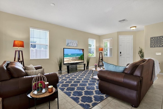 living room with light tile patterned floors and a textured ceiling