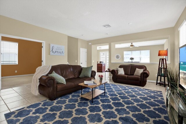 tiled living room with ceiling fan