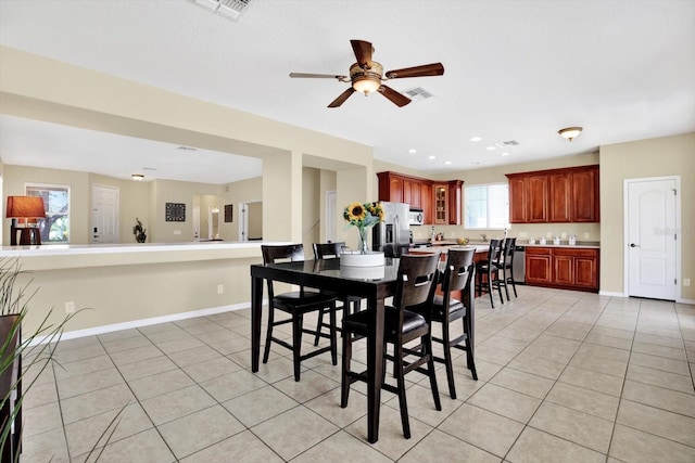 dining space with ceiling fan and light tile patterned floors