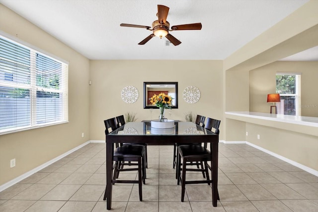 dining space featuring ceiling fan and light tile patterned floors