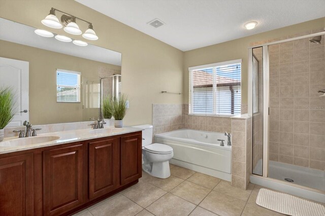 full bathroom with toilet, independent shower and bath, tile patterned floors, and vanity