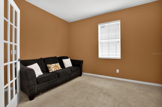 carpeted living room with french doors