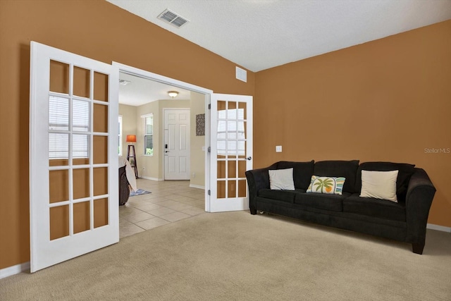 living room featuring light carpet and french doors