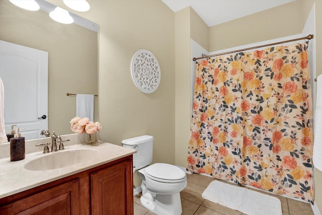 bathroom featuring toilet, tile patterned flooring, vanity, and curtained shower